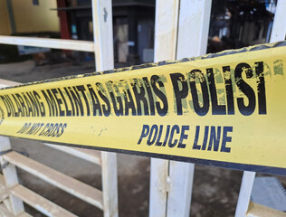 Crime Police Line Do Not Cross yellow ribbons	