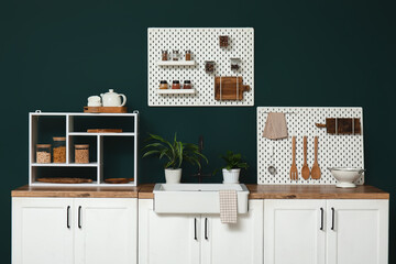 Stylish kitchen with pegboards and kitchenware