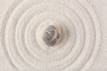Fototapeta na wymiar Stack of stones on sand with lines in Japanese rock garden, top view. Zen concept