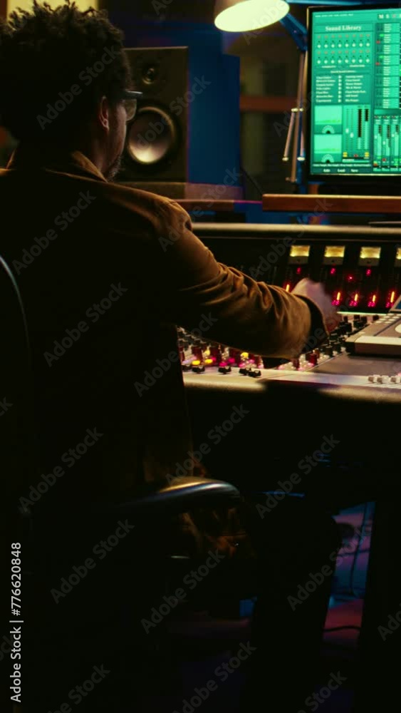 Poster vertical video tracking engineer working on a new album and recording hit song, handling mixing cons