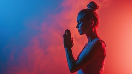A close-up of a woman doing a yoga pose on a blue-orange shaded background