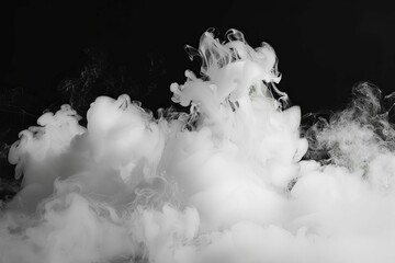 Dramatic white smoke swirling and billowing against black background, abstract photography