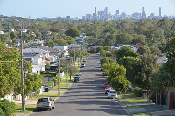 Residential houses street against Brisbane City skyline in Queensland Australia
