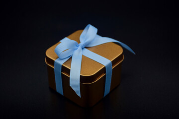 gift box in gold color with ribbon
