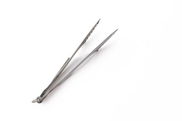 Stainless steel tweezers on white background