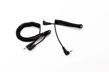 Black coiled audio cable on white background