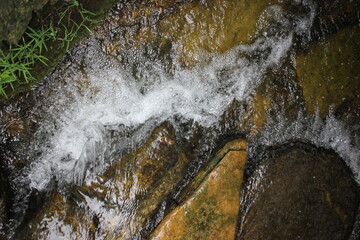 Fresh clean water flowing down the rough rocks.