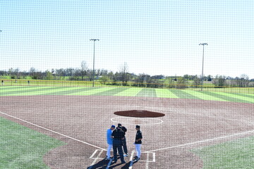 Coaches and Umpires on a Baseball Field