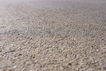 Fototapeta na wymiar A close up of a grey concrete surface with a lot of small rocks