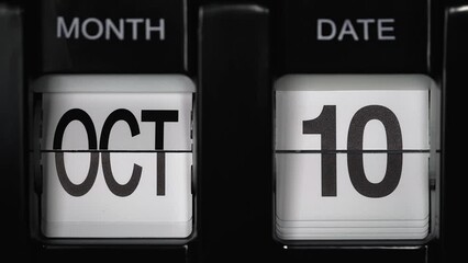 retro flip calendar with a date change from the ninth of October to the tenth of October. daily calendar with a change of days of the month. close up.