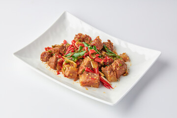 Stir-fried stewed beef shank with holy basil , chili and garlic served on white plate isolated on white background. Stir-fried holy basil is a very popular food in Thailand.