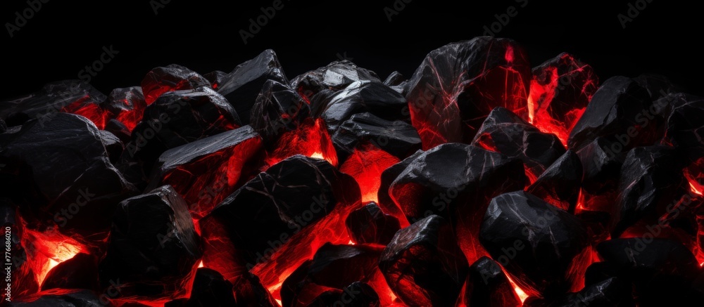 Canvas Prints a close-up view of a stack of coal illuminated by a vibrant red light, showcasing the dark and textu