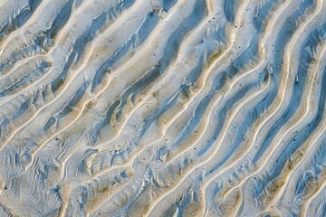 Intricate patterns in the sand created by gentle ocean waves, serene beach texture, abstract photo