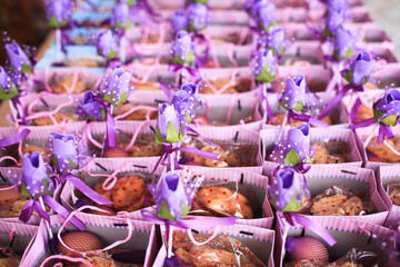 A row of “Bunga Telur” sitting on the floor. “Bunga Telur” are decorated eggs given as a gift to guests in a tradisional Malay wedding or others event in Malaysia.