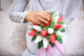 Close-up of wedding details. The bride's wedding ring on the finger. Malay Wedding day.