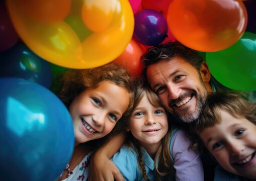 A man and two children are surrounded by balloons in a photo. Generative AI.