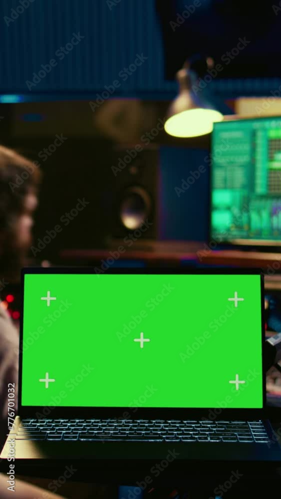 Poster vertical video audio technician leveling sound on recorder mixing console, having a laptop that show