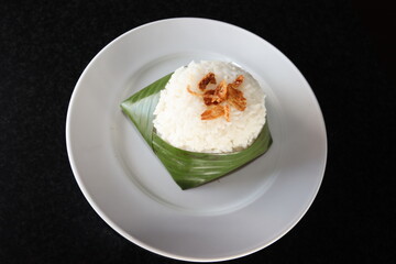 indonesian traditional food steam rice wrap with banana leaf