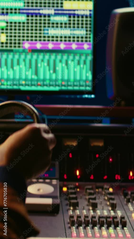 Poster vertical video african american music producer recording tracks and editing them in post production,