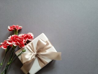 Gift box with red carnation flowers