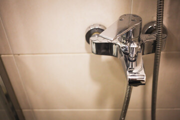 Shower faucet. Modern shower set in bathroom interior. Hygiene concept. Selective focus.