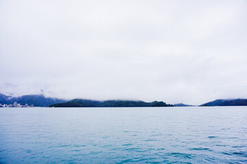 Sun Moon Lake，Nantou, Taiwan, Republic of China, 01 22 2024: The landscape of Sun Moon Lake (Ri Yue pond) in a cloudy and foggy day