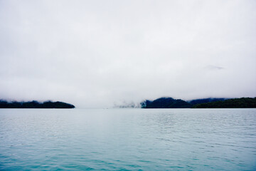 Naklejka na ściany i meble Sun Moon Lake，Nantou, Taiwan, Republic of China, 01 22 2024: The landscape of Sun Moon Lake (Ri Yue pond) in a cloudy and foggy day