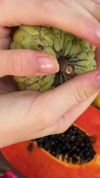Hard unripe fruit Noah and trying to break it with your hands needs to finish ripening Assorted fresh ripe fruits and vegetables. Food concept background. Top view. 