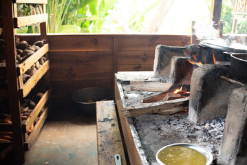 Cooking on wood stove in rustic wooden kitchen in the countryside