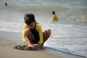 Child and person enjoying beach fun by the sea, playing and fishing in the sand on a sunny summer day - 776738249