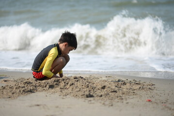Child and person enjoying beach fun by the sea, playing and fishing in the sand on a sunny summer day - 776738264