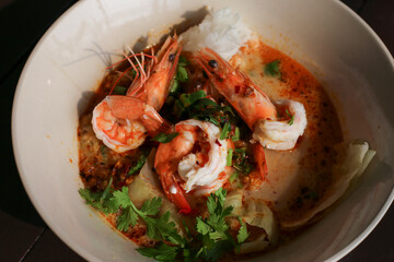 selective focus shrimp looks delicious in a bowl of tom yum shrimp noodles Placed on the table to decorate the table. cooking ideas