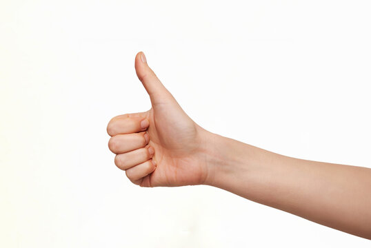 Hand showing thumbs up gesture isolated on white background