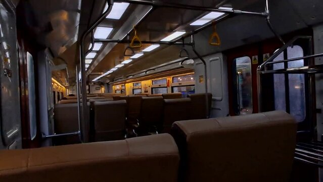 Public trains in Java, Indonesia are empty of passengers when it is almost dark. There were many empty seats on the intercity train and the carriages looked deserted