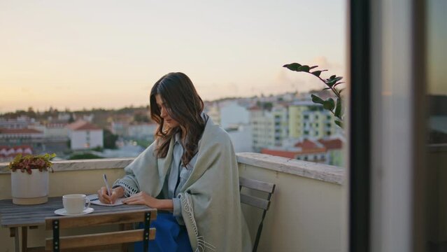 Romantic brunette writing notebook resting evening balcony closeup. Woman author