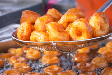 Traditional fried sweets lokma in sugar syrup