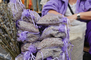 A stack of purple lavender bags fills the basket, creating a beautiful pattern