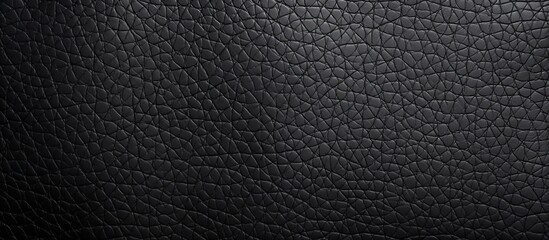 Luxurious black leather background featuring a sophisticated pattern of small squares, adding an...