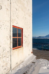 A detail of the Kjolnes Lighthouse by the Barents Sea on a sunny winter day in March, Berlevåg Norway
