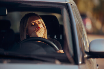 Driver Yawning Behind the Wheel in her Car. Sleepy drowsy woman trying to travel by car on a long...