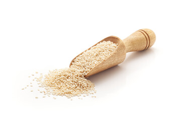 Front view of a wooden scoop filled with Organic White Sesame seeds (Sesamum indicum) or Til. Isolated on a white background.
