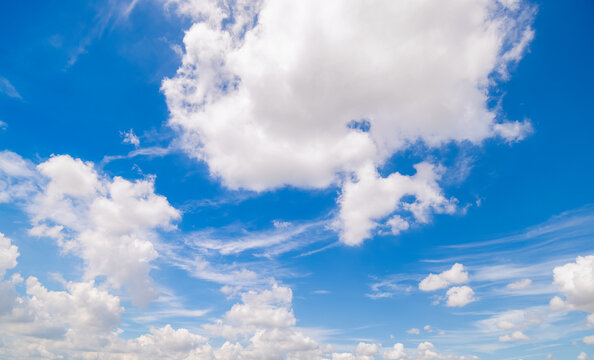 Panoramic view of clear blue sky and clouds, Blue sky background with tiny clouds. White fluffy clouds in the blue sky. Captivating stock photo featuring the mesmerizing beauty of the sky and clouds.