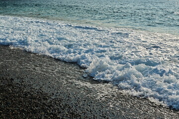 Wave on pebble beach. Plage de Porto beach on the island of Corsica in the Mediterranean Sea