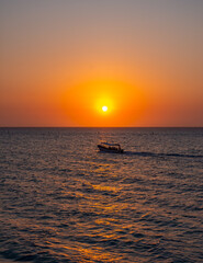 Serene sunset at Playa Blanca with a boat on calm waters