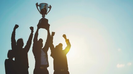 Team Lifting Trophy Against Sky. Capturing a victorious moment, this image features silhouettes of professionals raising a trophy together, embodying shared success and teamwork under a backlit sky.