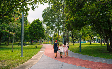 People walking in the Taman Tasik Titiwangsa natural public park in the Kuala Lumpur city, Malaysia