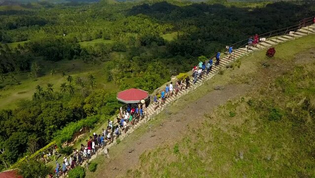 Carmen, Bohol, Philippines - Tourists climb the stairs to reach the top of the observatory of the famous Chocolate Hills Complex in Carmen, Bohol, Philippines.
