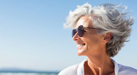 Portrait of a smiling woman wrapped in a blanket on the beach
