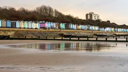 Beach huts on the North Sea coast at Frinton-on-Sea, Essex, England