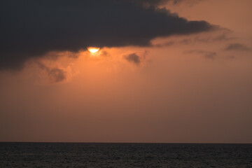 warm sun behind a dark cloud in the morning on vacation